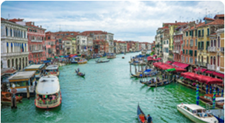 Venice canal with boats and colorful buildings